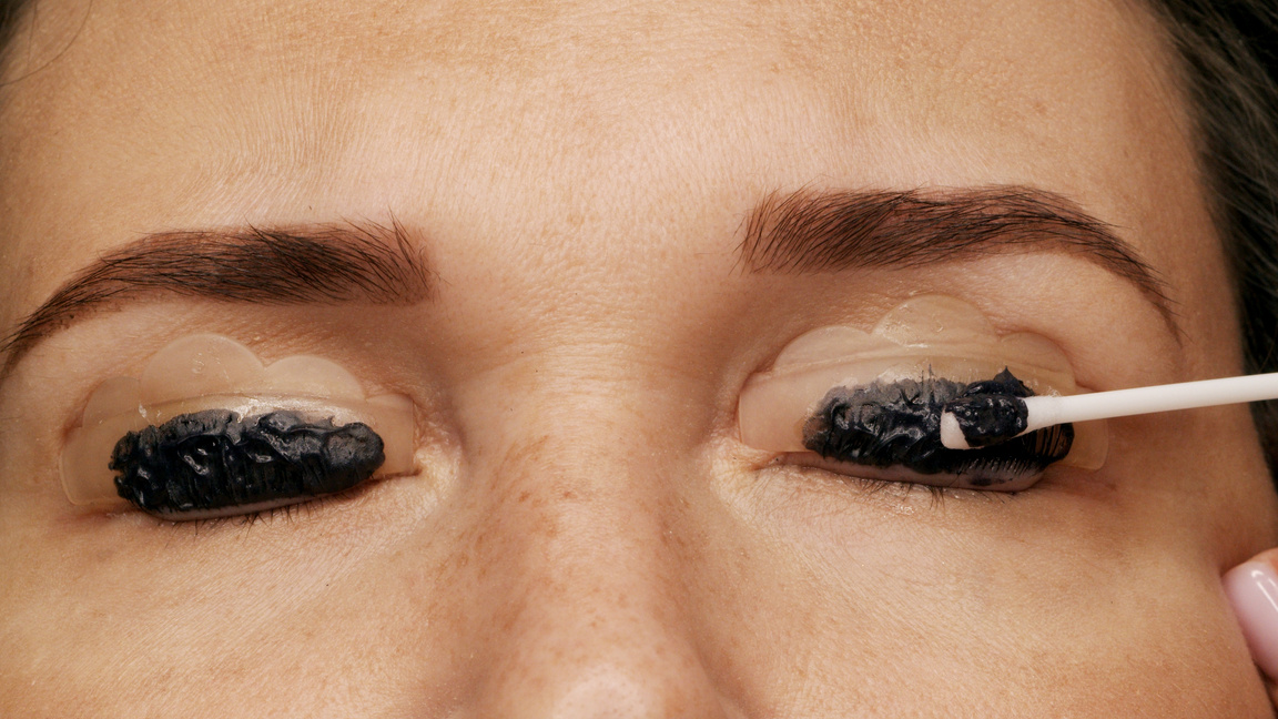 Cosmetologist Removes Black Eyelash Paint after Coloring. Profes